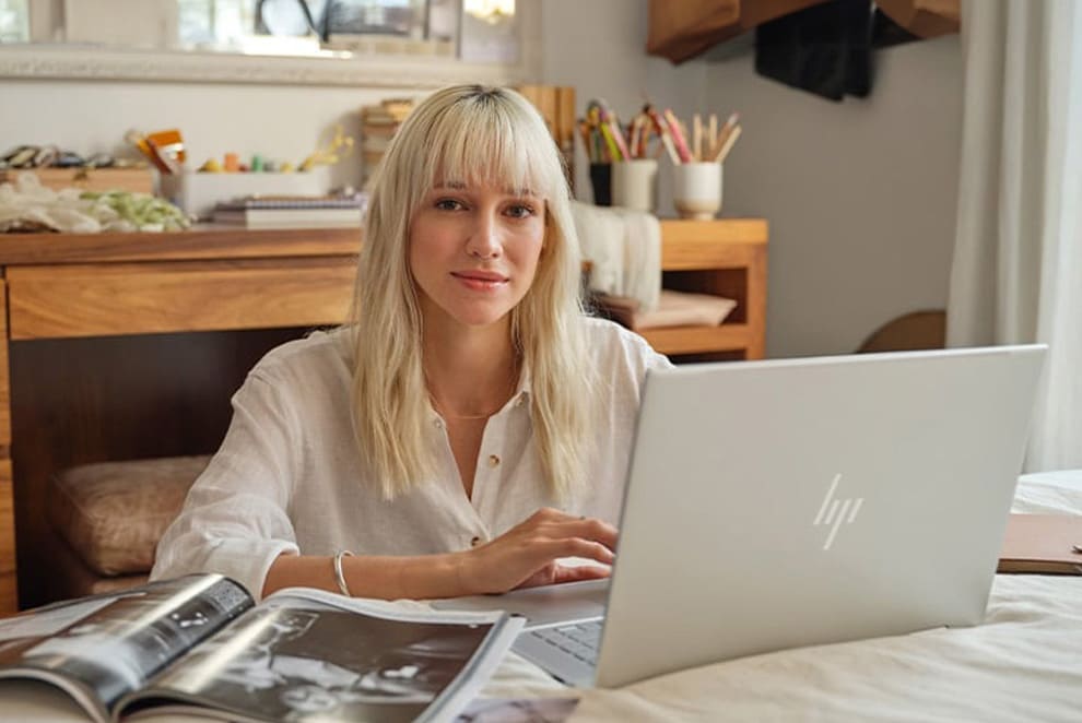 woman with her laptop looking at the camera