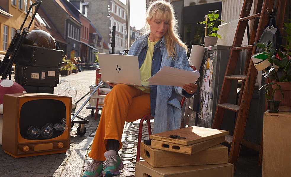 girl in street working with her laptop