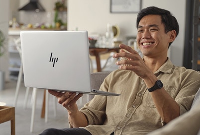 man holding laptop with happy face