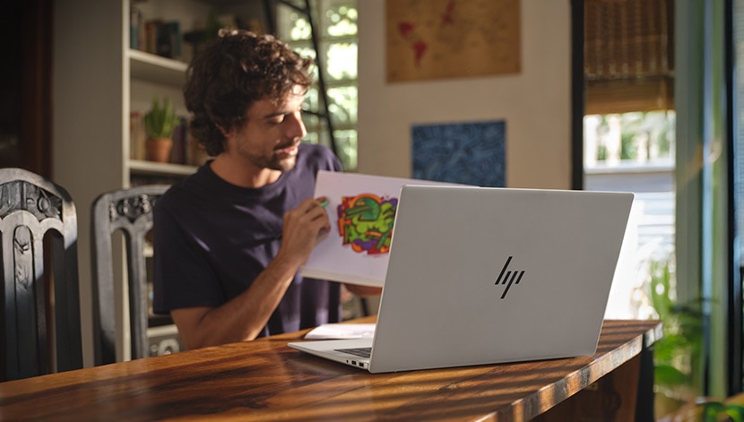 man is working with his top rated laptop