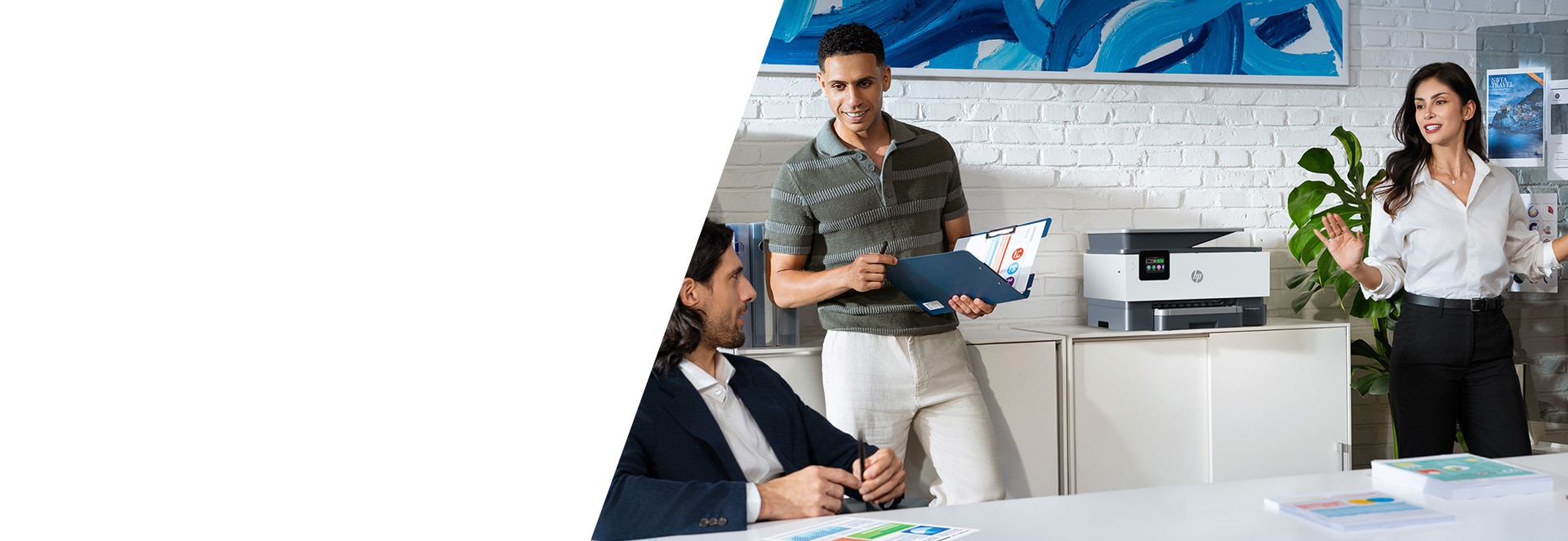 Three people discuss around HP officejet printer in a modern office.