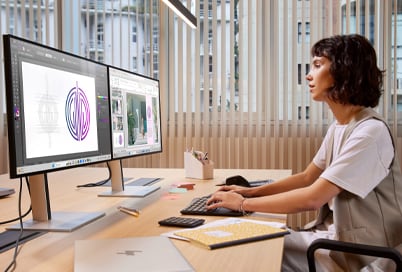 woman working in an office with HP business monitors