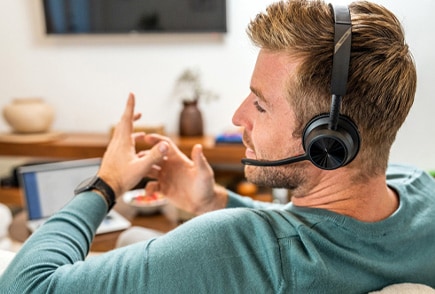 person having a meeting over the internet using a poly wireless headphone