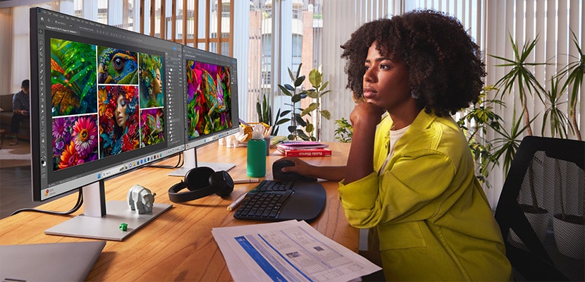 woman in yellow outfit working with hp monitor in an office