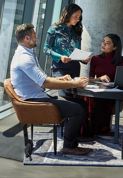 A work team discussing data while working on an HP Laptop