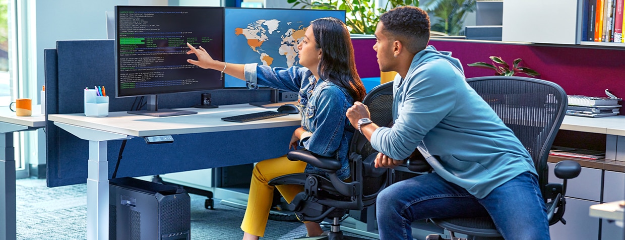 A lady showing a piece of code to a coworker, with an HP Products Setup Desk