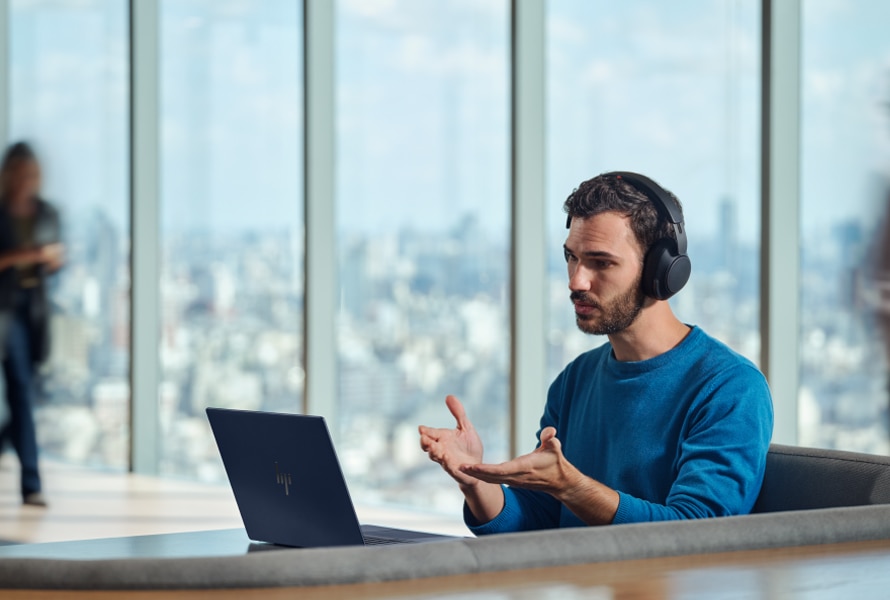 man having a conference call with his poly headset and his HP EliteBook Ultra G1q AI PC